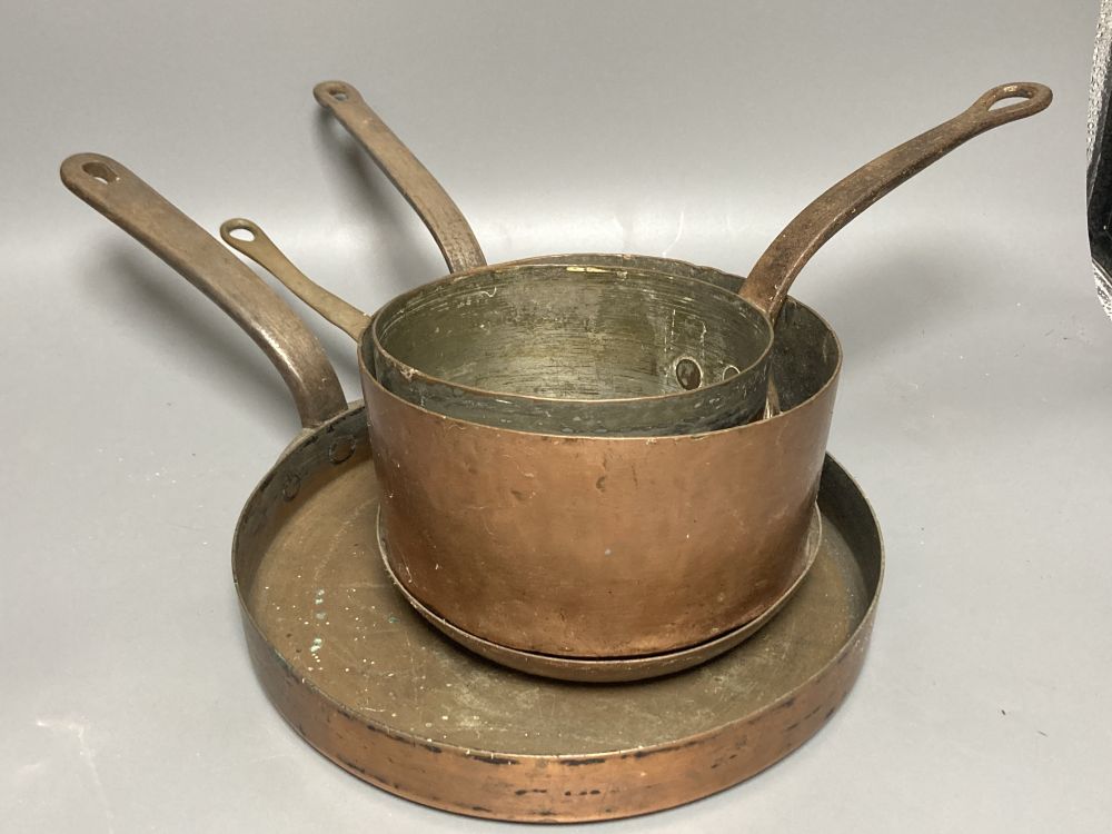 Two copper saucepans and two copper shallow pans, broadest 26cm